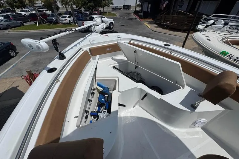 Slide: The Image of 2023 Sea Hunt Ultra 239 SE boat interior with open storage compartments and fishing gear. - 9