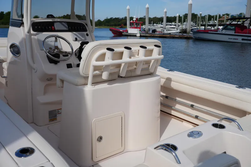 Slide: The Image of 2021 Grady-White Fisherman 216 boat interior with helm and rod holders at marina. - 17