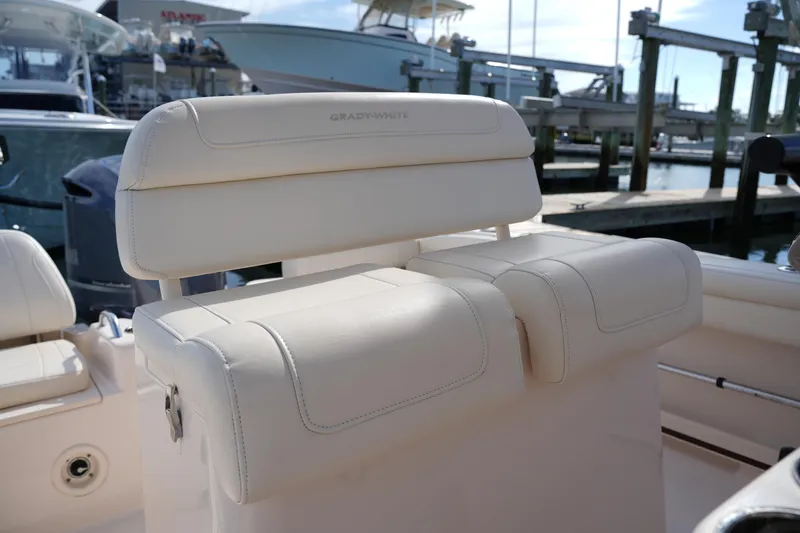 Slide: The Image of 2021 Grady-White Fisherman 216 boat seating, featuring luxurious white upholstery at a marina. - 18