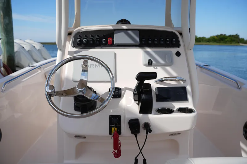 Slide: The Image of 2021 Grady-White Fisherman 216 boat console with steering wheel and controls. - 20