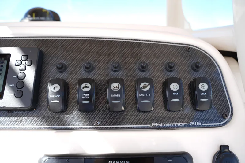 Slide: The Image of Control panel of 2021 Grady-White Fisherman 216 boat with labeled switches. - 23