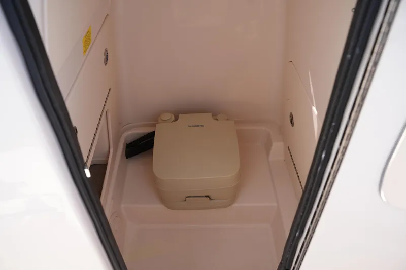 Slide: The Image of Portable toilet inside 2021 Grady-White Fisherman 216 boat compartment. - 28