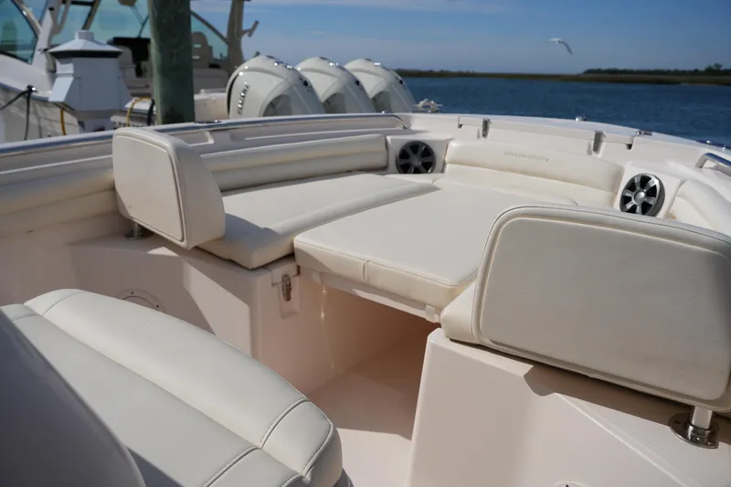 Slide: The Image of 2021 Grady-White Fisherman 216 boat interior with cushioned seating and speakers. - 30