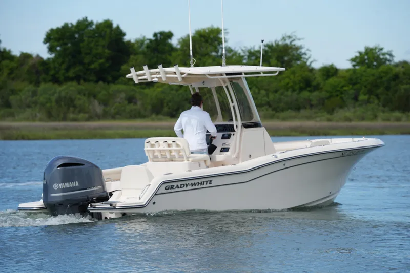 Slide: The Image of 2021 Grady-White Fisherman 216 boat cruising on a calm lake with Yamaha engine. - 7