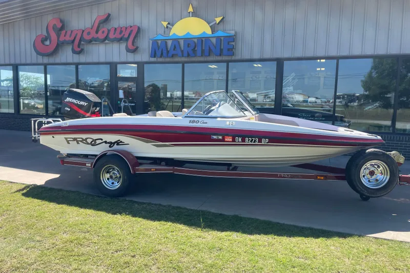 The Image of 2002 ProCraft 180 Combo boat on trailer outside Sundown Marine dealership. - 0