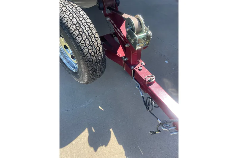Slide: The Image of Trailer hitch and tire of a 2002 ProCraft 180 Combo boat on pavement. - 12