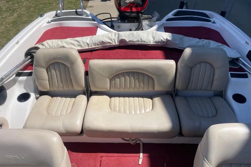 Slide: The Image of 2002 ProCraft 180 Combo boat interior with beige seats and red carpet. - 4