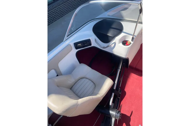 Slide: The Image of Interior of 2002 ProCraft 180 Combo boat with beige seating and red carpet. - 5