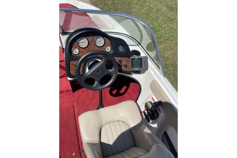 Slide: The Image of 2002 ProCraft 180 Combo boat dashboard with steering wheel and gauges. - 6