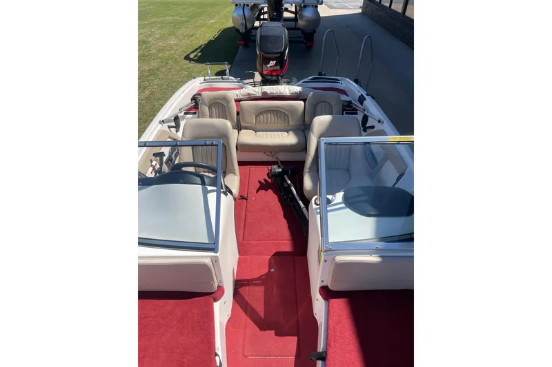 Slide: The Image of 2002 ProCraft 180 Combo boat interior with red carpet and beige seating. - 8