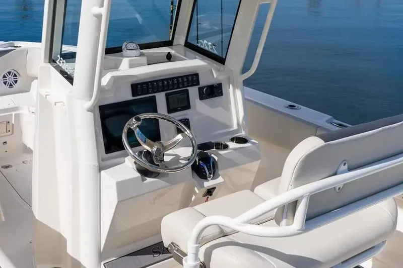 Slide: The Image of 2026 Sailfish 232 CC boat cockpit with steering wheel and control panel. - 3