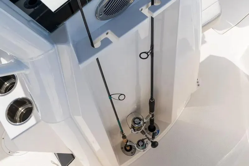 Slide: The Image of Fishing rods secured on a 2026 Sailfish 232 CC boat, showcasing rod holders and deck design. - 4