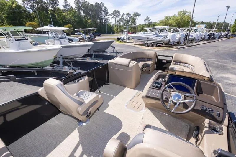 Slide: The Image of 2023 Bennington R23 Swingback pontoon boat interior with luxurious seating and modern dashboard. - 11