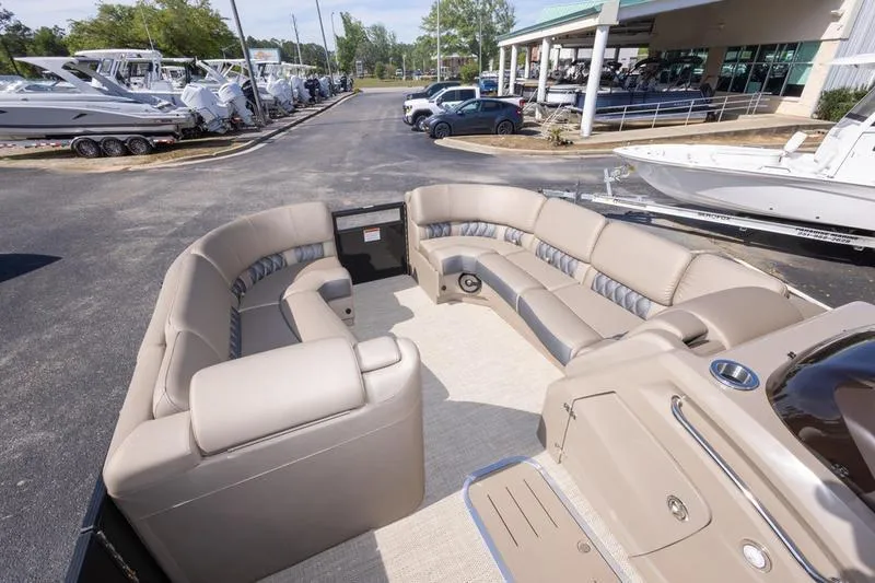 Slide: The Image of 2023 Bennington R23 Swingback pontoon boat with spacious seating and modern design at a dealership. - 14