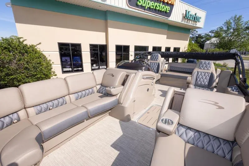 Slide: The Image of 2023 Bennington R23 Swingback pontoon boat with luxurious seating at a marine superstore. - 19