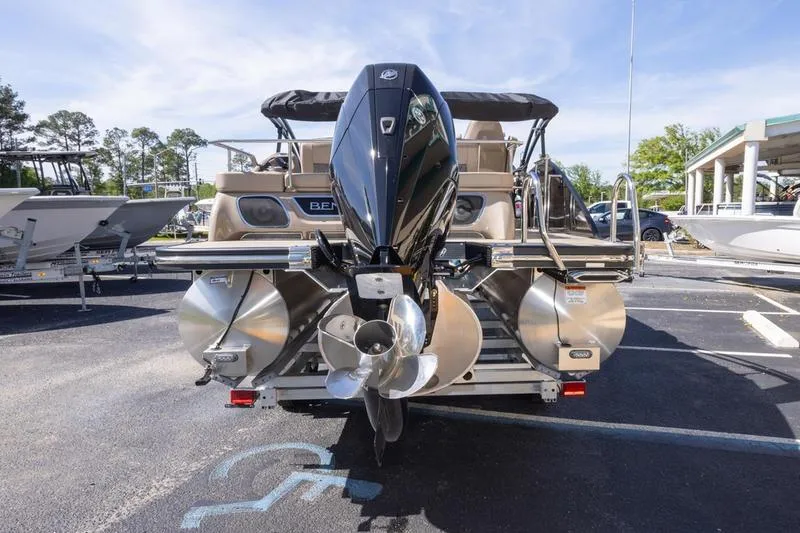 Slide: The Image of 2023 Bennington R23 Swingback pontoon boat with powerful outboard motor, parked outdoors. - 4