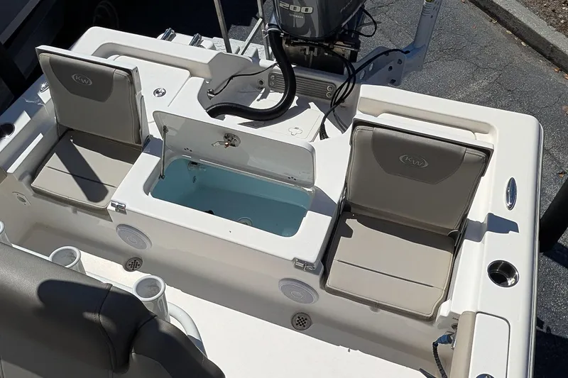 Slide: The Image of 2022 Key West 230 Bay Reef boat interior with seating and storage compartments. - 10