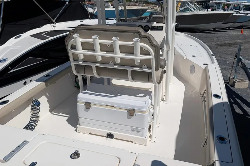 Slide: The Image of 2022 Key West 230 Bay Reef boat interior with rod holders and cooler. - 11