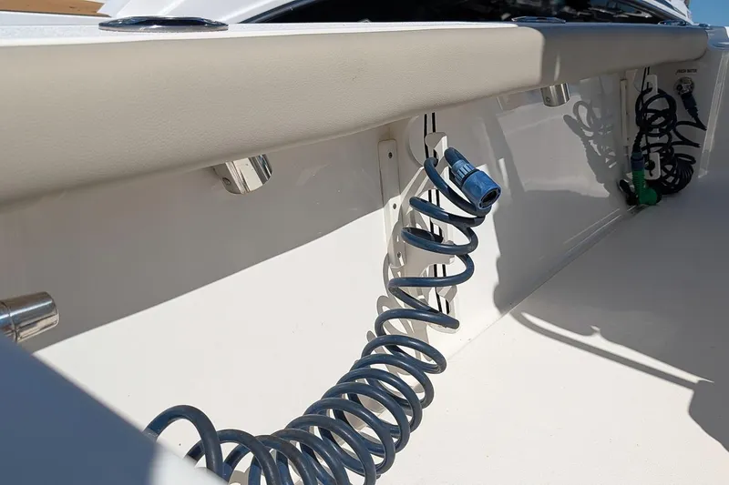 Slide: The Image of 2022 Key West 230 Bay Reef boat interior with coiled hose and fittings. - 12