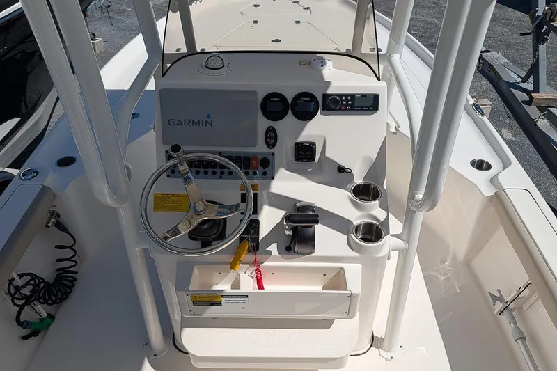 Slide: The Image of 2022 Key West 230 Bay Reef boat console with Garmin navigation system and steering wheel. - 14