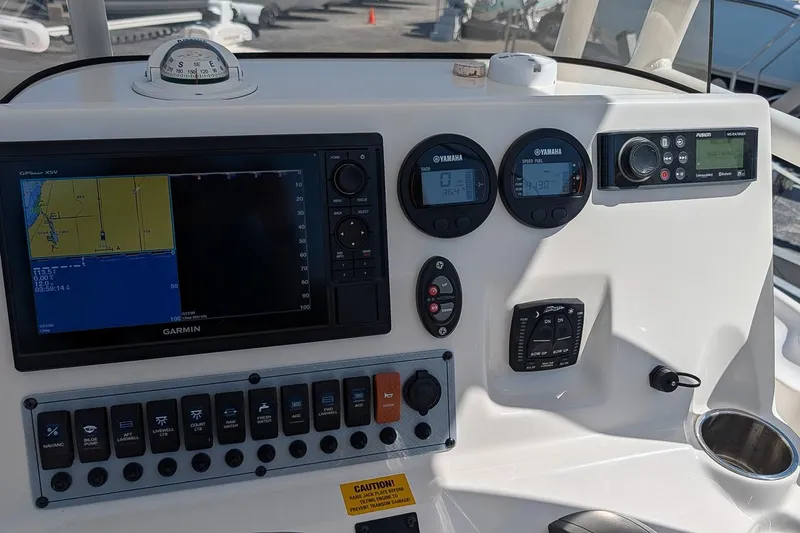 Slide: The Image of Dashboard of 2022 Key West 230 Bay Reef boat with Garmin GPS and Yamaha gauges. - 16