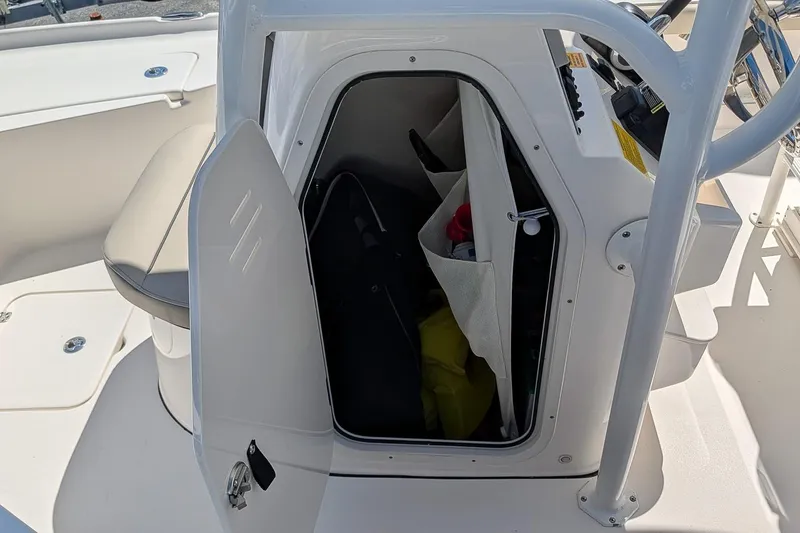 Slide: The Image of Open storage compartment on 2022 Key West 230 Bay Reef boat, showing interior organization. - 17