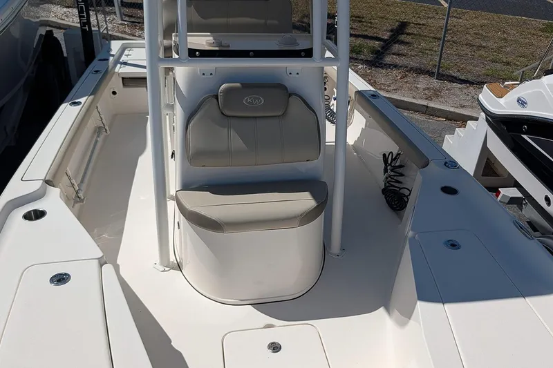 Slide: The Image of 2022 Key West 230 Bay Reef boat interior with seating and storage compartments. - 18