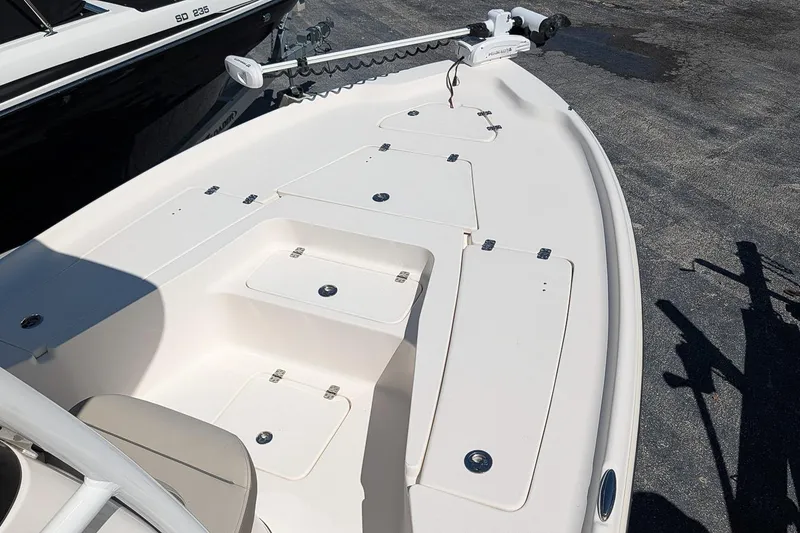 Slide: The Image of 2022 Key West 230 Bay Reef boat deck with storage compartments and trolling motor. - 19