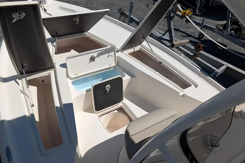Slide: The Image of 2022 Key West 230 Bay Reef boat with open storage compartments and seating. - 20