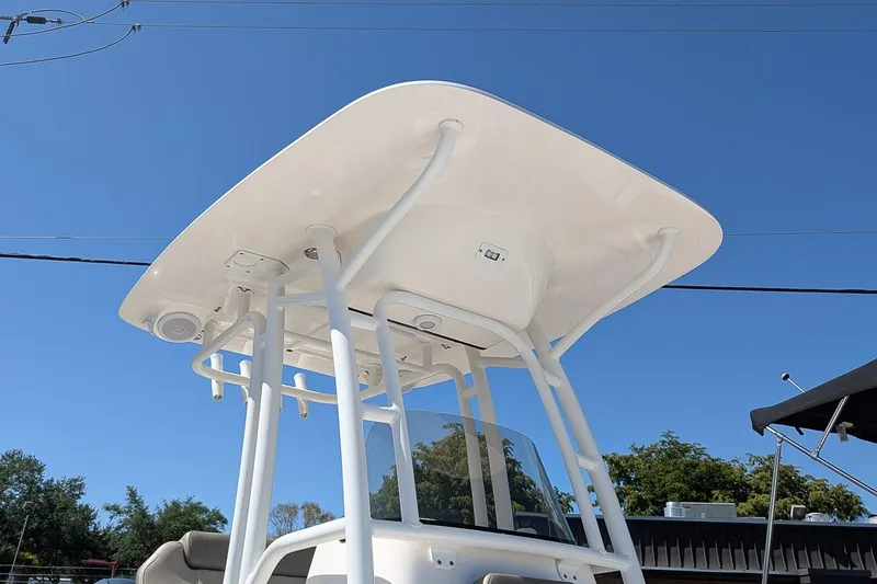 Slide: The Image of T-top of 2022 Key West 230 Bay Reef boat against clear blue sky. - 24