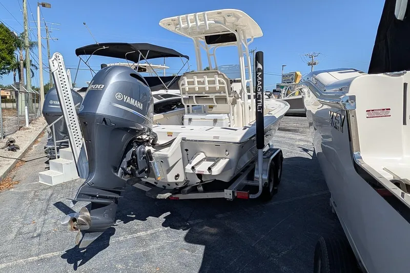 Slide: The Image of 2022 Key West 230 Bay Reef boat with Yamaha engine on trailer, parked outdoors. - 3