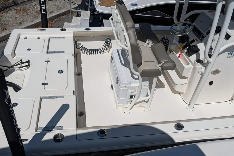 Slide: The Image of 2022 Key West 230 Bay Reef boat interior with seating and storage compartments. - 4