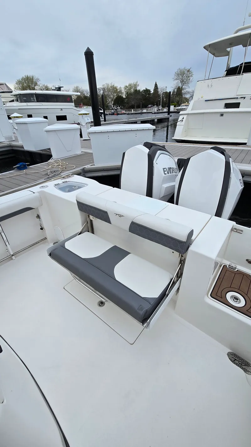 Slide: The Image of 2018 Tidewater 280 CC Adventure boat with bench seating at dock. - 10