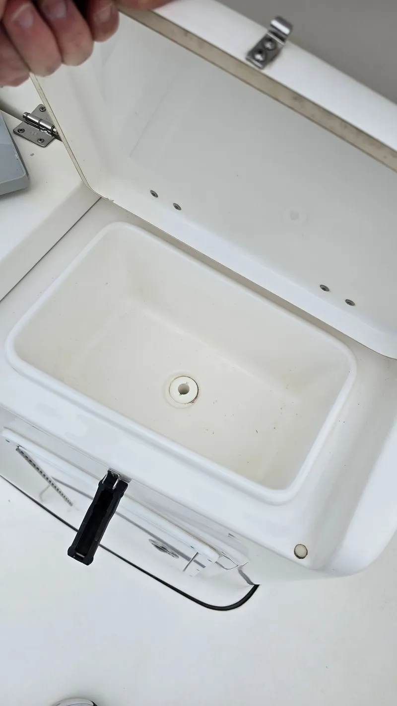 Slide: The Image of Open storage compartment in 2018 Tidewater 280 CC Adventure boat. - 13