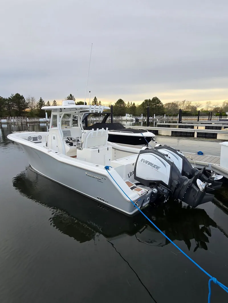 Slide: The Image of 2018 Tidewater 280 CC Adventure boat docked in harbor. - 2