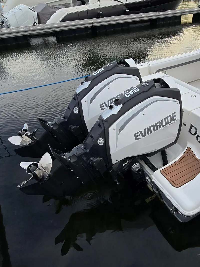 Slide: The Image of 2018 Tidewater 280 CC Adventure with Evinrude engines at dock. - 5