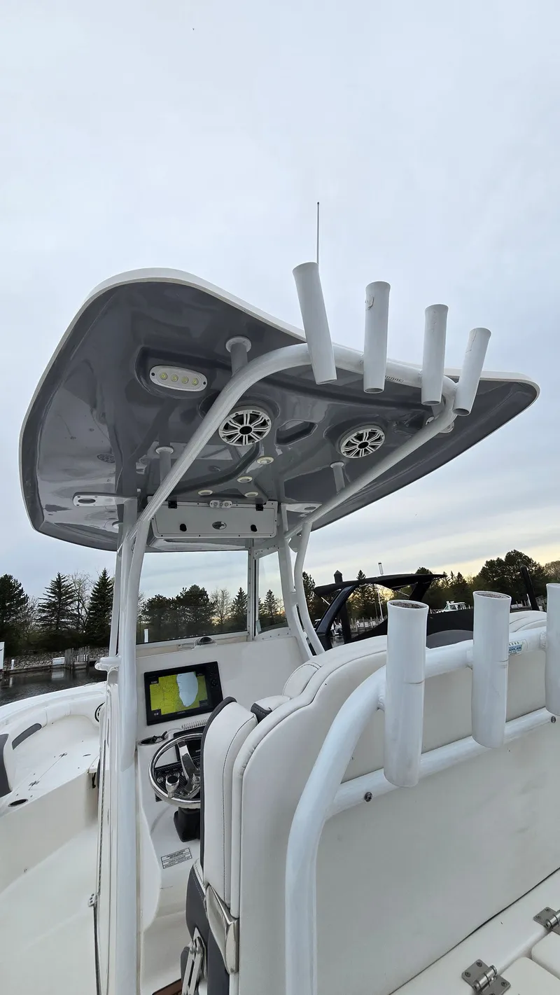 Slide: The Image of 2018 Tidewater 280 CC Adventure boat with helm and fishing rod holders. - 6