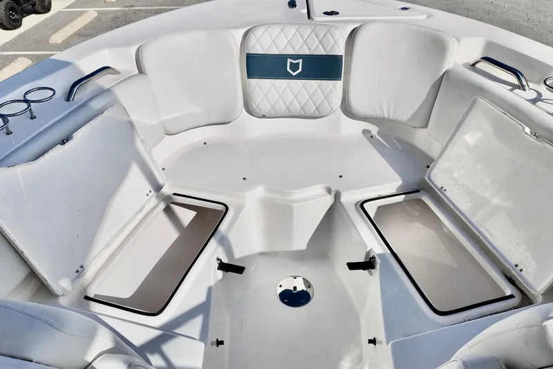Slide: The Image of 2024 Sea Fox 228 Commander boat interior with cushioned seating and storage compartments. - 13