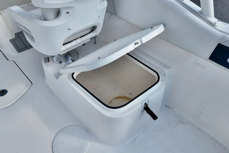 Slide: The Image of 2024 Sea Fox 228 Commander boat storage compartment with open lid, showcasing interior space. - 19