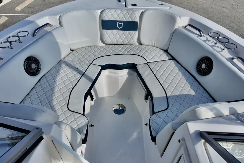 Slide: The Image of 2024 Sea Fox 228 Commander boat interior with cushioned seating and cup holders. - 22