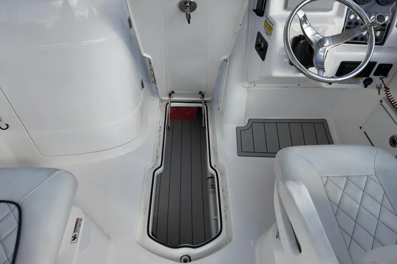 Slide: The Image of 2024 Sea Fox 228 Commander boat interior with steering wheel and seating. - 4