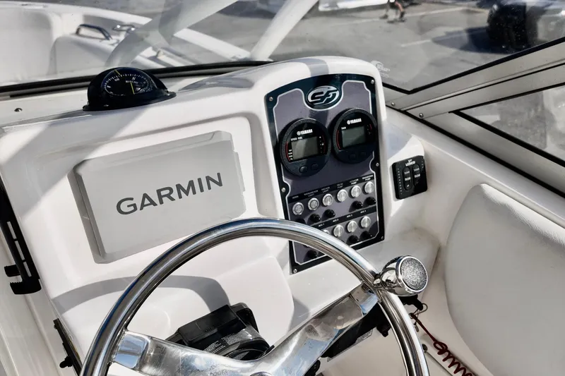 Slide: The Image of 2024 Sea Fox 228 Commander dashboard with Garmin navigation and Yamaha controls. - 7
