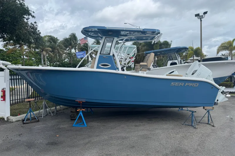 The Image of 2026 Sea Pro 242 Center Console boat on stands outdoors. - 0