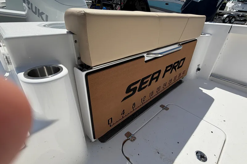 Slide: The Image of 2026 Sea Pro 242 Center Console boat with bench seat and cup holder. - 25