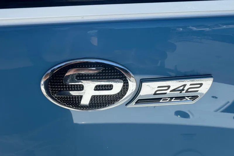 Slide: The Image of Sea Pro 242 Center Console 2026 boat emblem on blue background. - 35