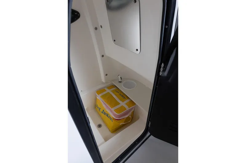 Slide: The Image of Manufacturer Provided Image: Interior storage compartment of 2026 Sea Pro 242 Center Console boat with life jacket. - 42