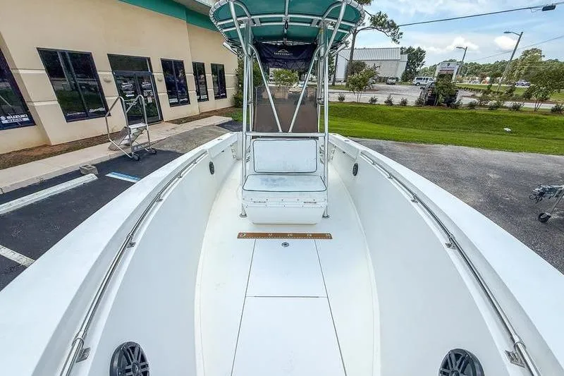Slide: The Image of 1997 Contender 21 Open boat with center console and T-top, parked outdoors. - 11