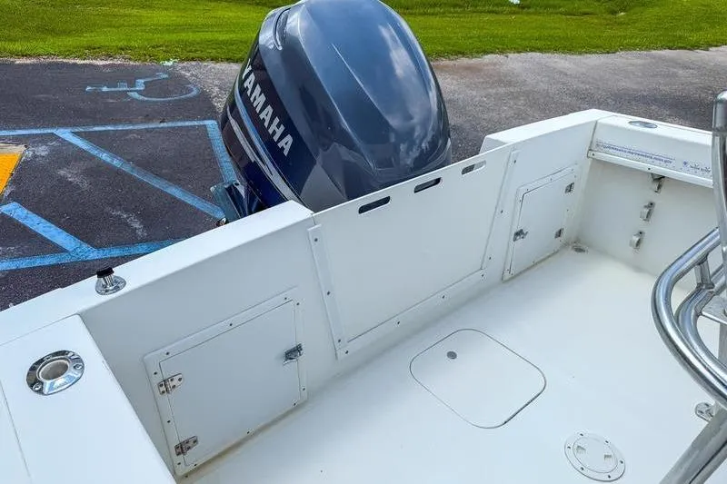 Slide: The Image of 1997 Contender 21 Open boat with Yamaha outboard motor, parked on pavement. - 12