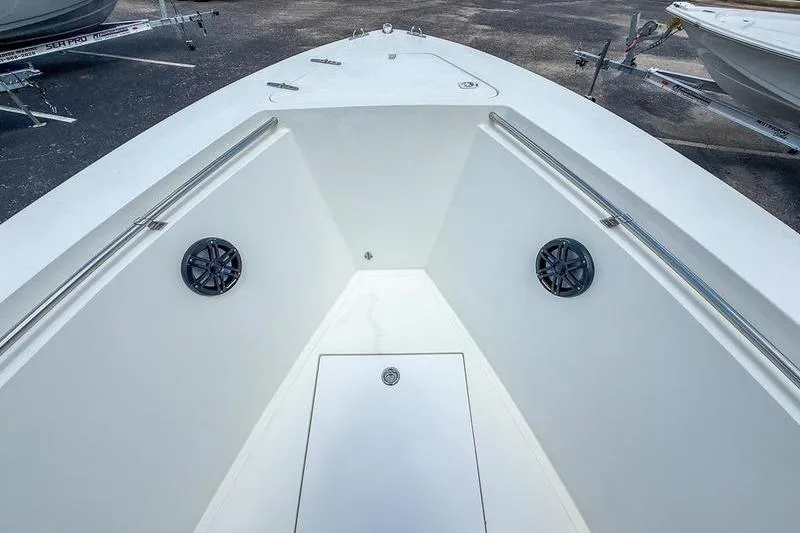 Slide: The Image of Bow view of a 1997 Contender 21 Open boat, featuring clean white deck and railings. - 13