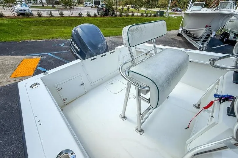 Slide: The Image of 1997 Contender 21 Open boat with Yamaha outboard motor, featuring a cushioned seat. - 14